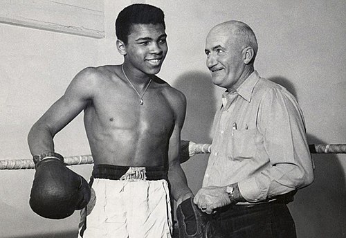 Muhammad Ali with trainer Angelo Dundee in boxing gym - showing the mentorship behind the champion